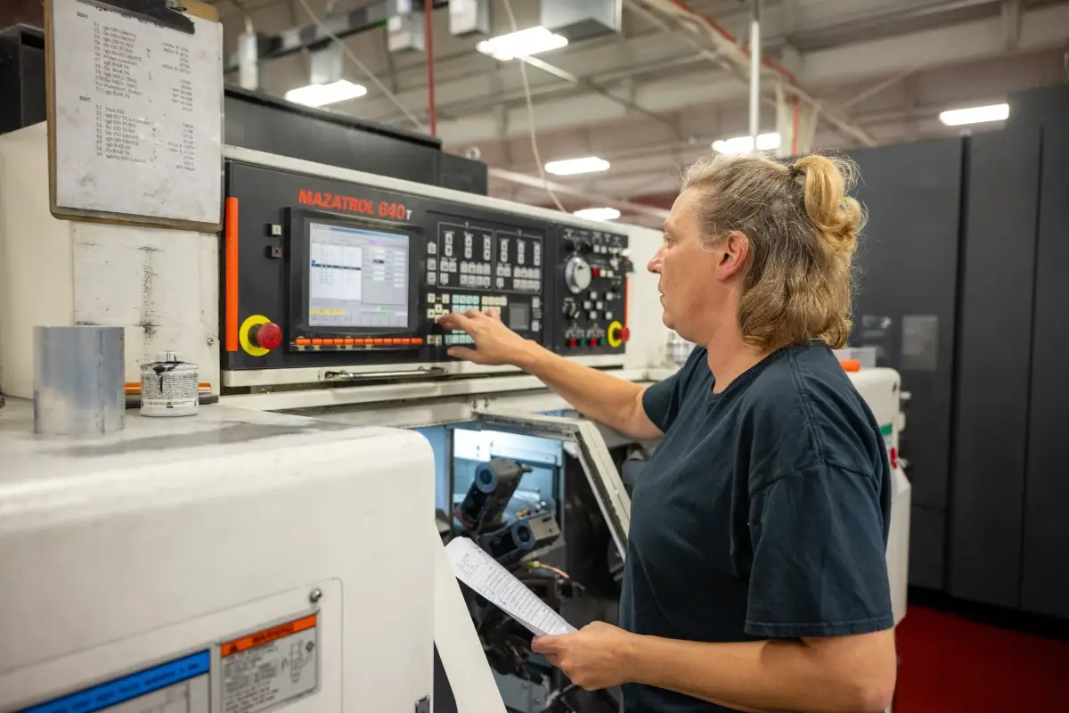 Engineer operating CNC machine